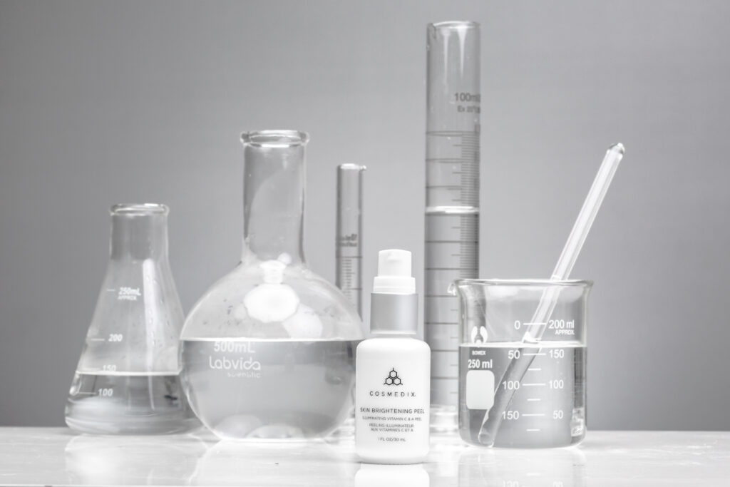 Skin Brightening Stading Straight on with beakers on light grey